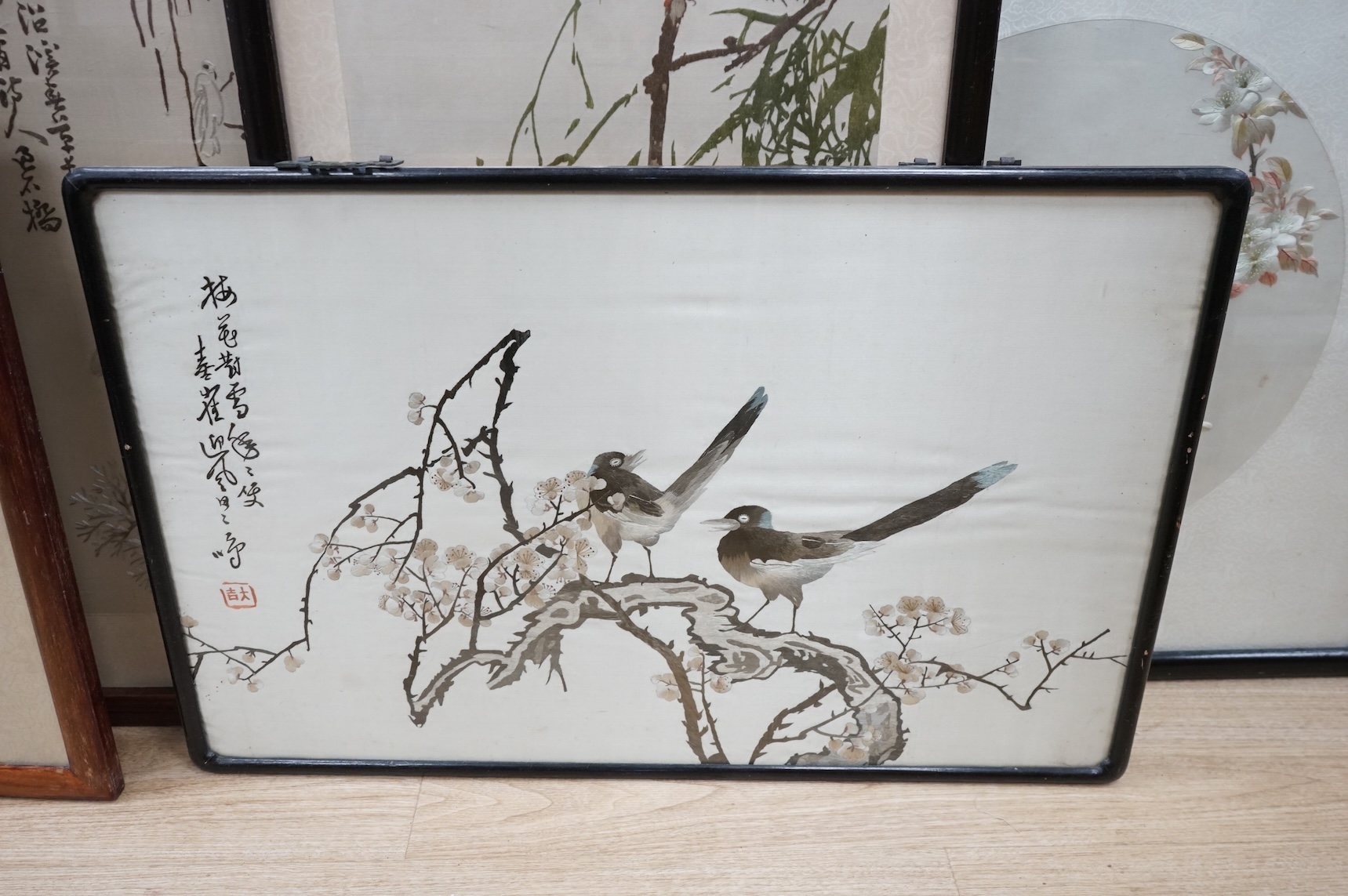 Seven Chinese embroideries on silk, mountainous landscapes and birds, largest 121cm high